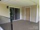 An outdoor patio area features beige siding, and a beige door under an overhang at 1985 Lancer Ct, Gastonia, NC 28054