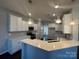 Modern kitchen with white cabinets, stainless steel appliances, and an island at 2031 Killian Creek Dr, Denver, NC 28037