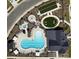 Aerial view of a community pool, jacuzzi, firepit, and recreational area with a bocce court and room for yard games at 212 Portrait Way, Indian Trail, NC 28079