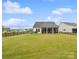 Expansive backyard with lush grass, fencing, and a charming covered patio at 212 Portrait Way, Indian Trail, NC 28079