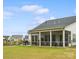Spacious backyard featuring a screened porch, perfect for outdoor relaxation and entertaining at 212 Portrait Way, Indian Trail, NC 28079