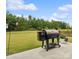 Spacious backyard with a barbecue grill and patio, ideal for outdoor entertaining at 212 Portrait Way, Indian Trail, NC 28079