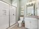 Modern bathroom with a glass-enclosed shower and decorative patterned tile flooring at 212 Portrait Way, Indian Trail, NC 28079