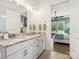 Bathroom with granite countertops, double sinks, and a view of a bedroom at 212 Portrait Way, Indian Trail, NC 28079