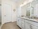 Bright bathroom with a double vanity, a granite countertop, and a large mirror at 212 Portrait Way, Indian Trail, NC 28079