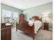 Bedroom with large windows, carpet flooring, and dark wooden furniture at 212 Portrait Way, Indian Trail, NC 28079