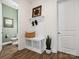 Cozy entryway featuring wooden flooring, coat rack and view into a half bathroom at 212 Portrait Way, Indian Trail, NC 28079