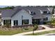 A modern farmhouse-style home with a black metal roof, white siding, and manicured landscaping at 212 Portrait Way, Indian Trail, NC 28079