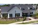 A beautifully landscaped exterior of a modern farmhouse-style home with a metal roof and manicured lawn at 212 Portrait Way, Indian Trail, NC 28079