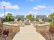 Community fire pit area with brick surround and seating, perfect for outdoor gatherings at 212 Portrait Way, Indian Trail, NC 28079