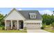 Charming home with stone and siding exterior, a two-car garage, and a well-manicured lawn at 212 Portrait Way, Indian Trail, NC 28079