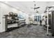 Well-equipped gym with weights, machines, and a mounted television for a complete workout experience at 212 Portrait Way, Indian Trail, NC 28079