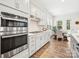 Modern kitchen showcasing stainless steel appliances and a view into the bright breakfast nook at 212 Portrait Way, Indian Trail, NC 28079
