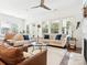 Bright living room with a cozy atmosphere, featuring neutral decor, a ceiling fan, and a fireplace at 212 Portrait Way, Indian Trail, NC 28079