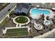 View of the recreational area, including community pool, jacuzzi, firepit, bocce court, and room for yard games at 212 Portrait Way, Indian Trail, NC 28079
