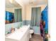 Quaint bathroom with ocean themed blue tiled walls and ocean life shower curtain at 2485 Nc Highway 109 S Hwy, Mount Gilead, NC 27306