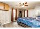 Bedroom featuring laminate floors, a queen bed, and two windows for natural light at 2485 Nc Highway 109 S Hwy, Mount Gilead, NC 27306