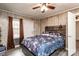 Bedroom features wood-paneled walls, a floral bedspread and window with dark curtains at 2485 Nc Highway 109 S Hwy, Mount Gilead, NC 27306
