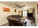 Comfortable living room with a plush leather sofa, large windows, and a ceiling fan for year-round comfort at 2485 Nc Highway 109 S Hwy, Mount Gilead, NC 27306