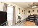 Comfortable living room with a plush leather sofa, large windows, and a ceiling fan for year-round comfort at 2485 Nc Highway 109 S Hwy, Mount Gilead, NC 27306