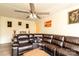 Comfortable living room with a plush leather sofa, large windows, and a ceiling fan for year-round comfort at 2485 Nc Highway 109 S Hwy, Mount Gilead, NC 27306