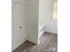 Laundry room with built-in shelving, vinyl flooring, and exterior access at 285 E Steele St, Salisbury, NC 28144