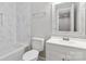 Bathroom with white vanity, marble tile, and bathtub at 307 E Old Highway 74 None, Monroe, NC 28112