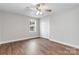 Bright bedroom with wood floors, ceiling fan, and spacious closet at 307 E Old Highway 74 None, Monroe, NC 28112