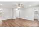 Spacious bedroom with hardwood floors, ceiling fan, and access to bathroom at 307 E Old Highway 74 None, Monroe, NC 28112