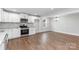Spacious dining area adjacent to a modern kitchen with hardwood floors at 307 E Old Highway 74 None, Monroe, NC 28112