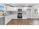 Modern kitchen with white cabinets, granite countertops, and stainless steel appliances at 307 E Old Highway 74 None, Monroe, NC 28112