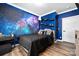 Themed bedroom with a galaxy mural and built-in shelving at 360 Country Ridge Rd, Rockwell, NC 28138