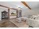 Spacious living room with hardwood floors, exposed beams, and a large sectional sofa at 360 Country Ridge Rd, Rockwell, NC 28138