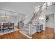 Formal staircase with hardwood floors and a view of the dining room at 3735 Providence Manor Rd, Charlotte, NC 28270