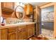 Modern bathroom with wood cabinets and a large oval mirror at 375 W Rambo Rd, Rock Hill, SC 29730