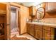 Bathroom boasts wood cabinets, a round mirror, and a shower with patterned curtain at 375 W Rambo Rd, Rock Hill, SC 29730