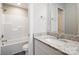 Clean bathroom with granite countertop, white cabinets, and a shower/tub combo at 3939 Newhall Dr, Hickory, NC 28601