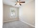 Well-lit bedroom featuring gray carpet, a ceiling fan, and a window at 3939 Newhall Dr, Hickory, NC 28601