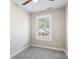 Bright bedroom with gray carpeting, ceiling fan, and a large window at 3939 Newhall Dr, Hickory, NC 28601
