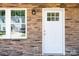 House exterior with stone facade, white door, and two large windows at 3939 Newhall Dr, Hickory, NC 28601