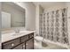 Clean bathroom with dark vanity, shower/tub combo, and patterned curtain at 40196 Crooked Stick Dr, Lancaster, SC 29720