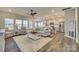 Open living room and kitchen with hardwood floors, island, and stainless steel appliances at 40196 Crooked Stick Dr, Lancaster, SC 29720