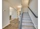 Staircase with gray carpet and dark wood railing at 40196 Crooked Stick Dr, Lancaster, SC 29720