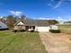 Brick ranch home with attached garage and landscaped yard at 402 Beaver Dam Church Rd, Shelby, NC 28152