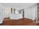 Open living area with hardwood floors and kitchen bar at 513 N Graham St # 1B, Charlotte, NC 28202