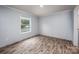 Well-lit bedroom featuring wood-look floors and a window at 607 Stewart Ct, Statesville, NC 28677