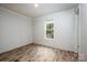 Simple bedroom with wood-look floors and a window at 607 Stewart Ct, Statesville, NC 28677