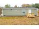 Exterior view showing a light green mobile home with yard at 607 Stewart Ct, Statesville, NC 28677