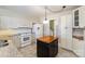 White kitchen cabinets, granite counters, and island at 644 Dogwood Rd, Statesville, NC 28677