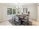 Elegant dining room with wood table, gray chairs, and a statement wall at 7024 Pleasant Dr, Charlotte, NC 28211